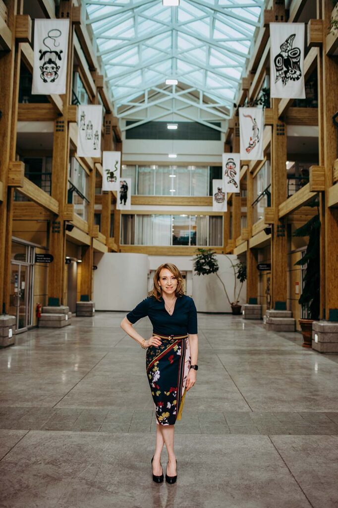 Catherine standing in the admin building of the University of Northern British Columbia