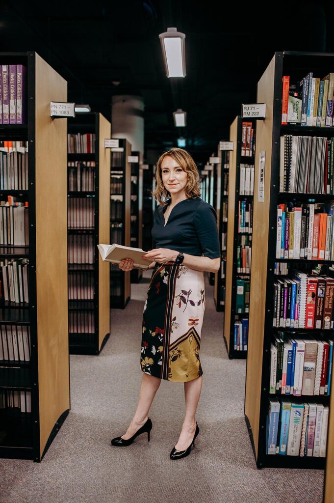 Catherine Reading a book in the library